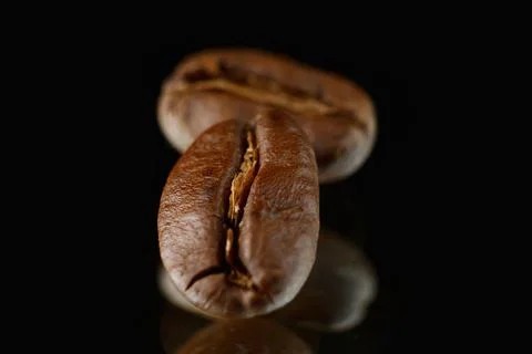 Coffee beans on a black background. Coffee on a black background with reflect Stock Photos