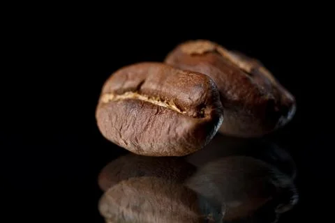 Coffee beans on a black background. Coffee on a black background with reflect Stock Photos