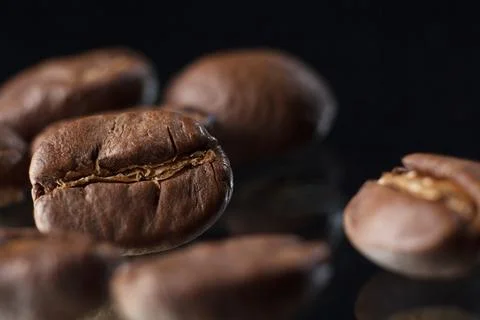 Coffee beans on a black background. Coffee on a black background with reflect Stock Photos