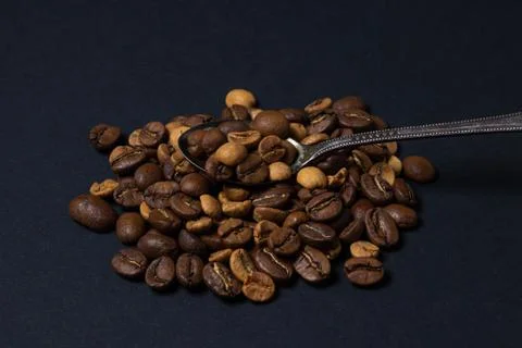 Coffee beans on a black background. Stock Photos