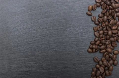Coffee beans on black background of slate or stone background with copy space Stock Photos