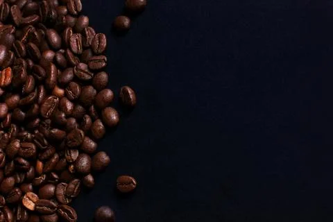 Coffee beans on black stone background Stock Photos
