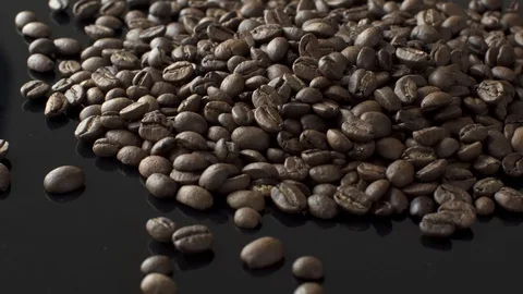 Coffee beans on a black table Stock Footage 87512441