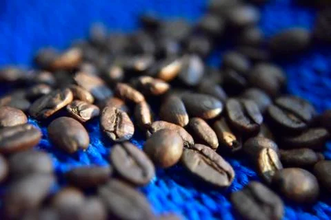 Coffee beans on the blue background close-up Stock Photos