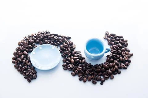 Coffee beans with blue espresso dishware Stock Photos
