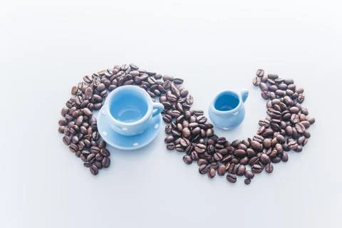 Coffee beans with blue espresso dishware Stock Photos
