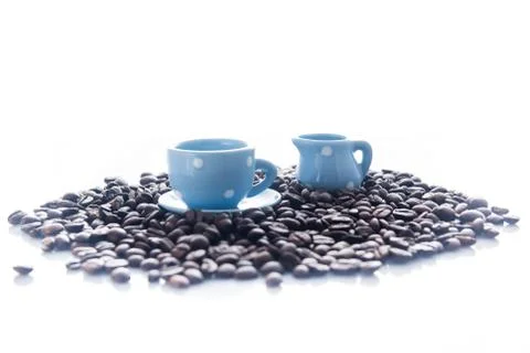 Coffee beans with blue espresso dishware Stock Photos