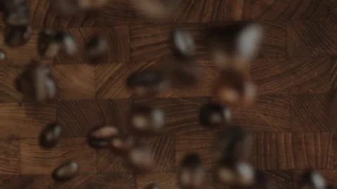 Coffee Beans Bouncing Slow Motion - Wooden Background - Motion Towards Camera Stock Footage 154471145