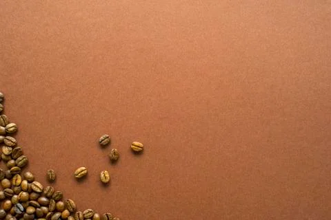Coffee beans on brown background close up Stock Photos