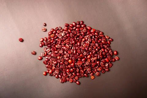Coffee beans on a brown background close-up. Stock Photos