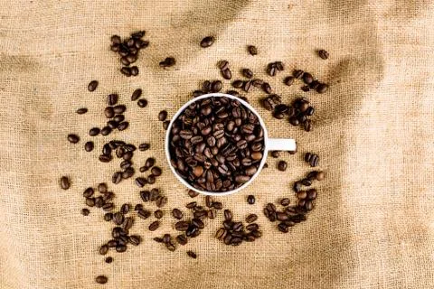 Coffee beans on brown, structured background Stock Photos