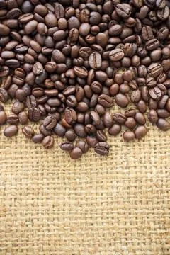 Coffee beans on burlap background. over light Stock Photos