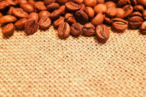 Coffee beans on burlap background Stock Photos
