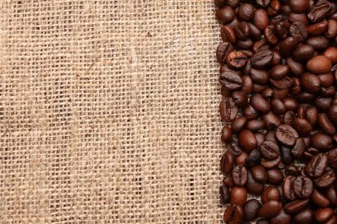 Coffee beans on burlap background Stock Photos