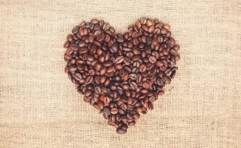 Coffee beans on burlap background Stock Photos