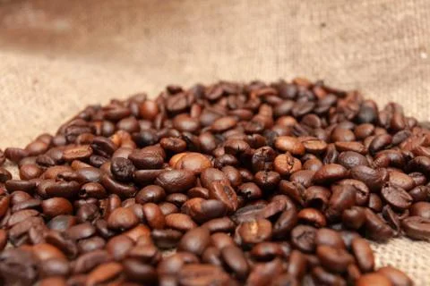 Coffee beans on burlap background Stock Photos