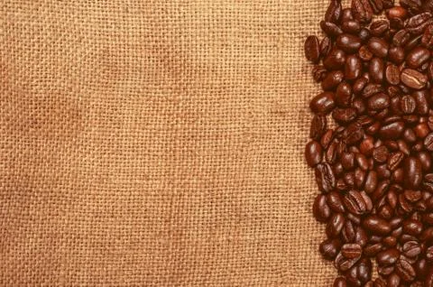 Coffee beans on burlap Stock Photos