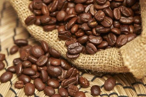 Coffee beans on burlap Stock Photos