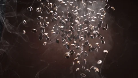 Coffee beans burst and fall down through the smoke Stock Footage 120073558