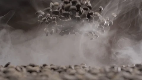 Coffee beans burst and fall down through the smoke Stock Footage 120073667