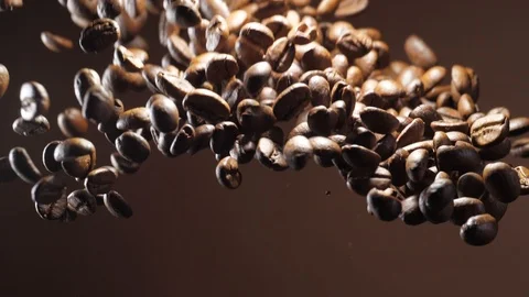 Coffee beans burst explosion on brown background Stock Footage 120203690