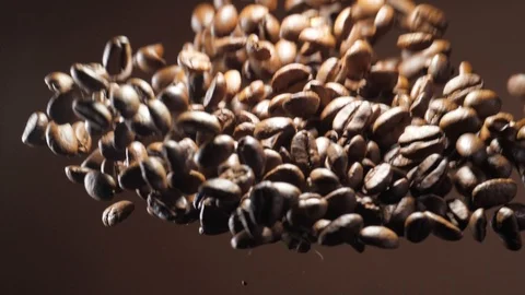 Coffee beans burst explosion on brown background Stock Footage 121230074