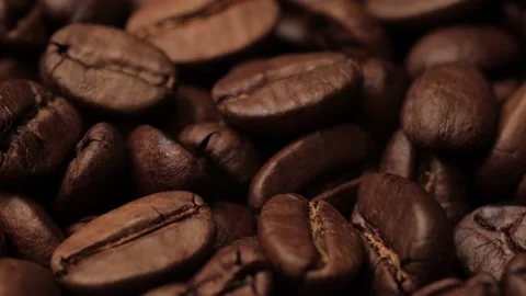 Coffee beans. Camera slowly pans down to show macro shot of awesome roasted Video stock 168661091