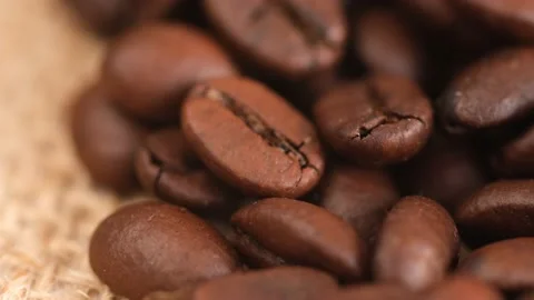 Coffee beans on canvas, cam moves , close up.Freshly roasted coffee on canvas Stock Footage 171846724