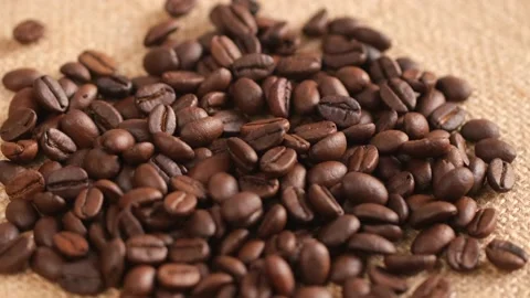 Coffee beans on canvas, cam moves , close up.Freshly roasted coffee on canvas Stock Footage 171846798