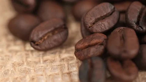 Coffee beans on canvas, cam moves , close up.Freshly roasted coffee on canvas Stock Footage 172359468
