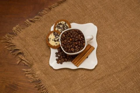 Coffee beans cinnamon cookie white cup and saucer Stock Photos