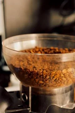 Coffee beans in  clear container at  coffee shop during morning hours. beans  Stock Photos