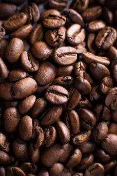 Coffee beans close up against the background of a coffee beans. Morning espresso Stock Photos