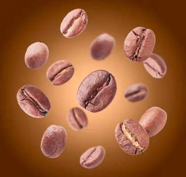 Coffee beans close-up fly on a brown background. Levitation Stock Photos