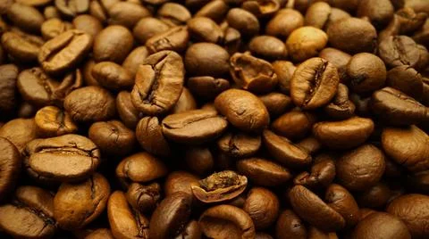 Coffee beans close-up in motion. Roasted Coffee beans close up. coffee beans. Stock Photos
