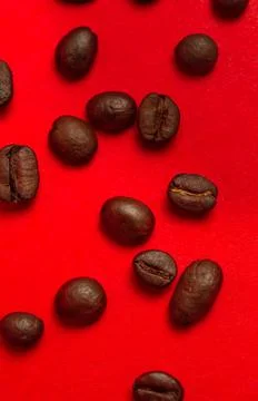 Coffee beans close-up on a red background. Stock Photos