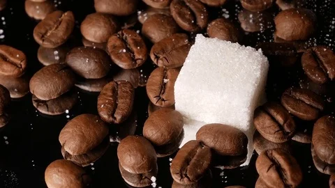 Coffee beans close-up rotate with a mirror image and a sugar cube Stock Footage 74775339