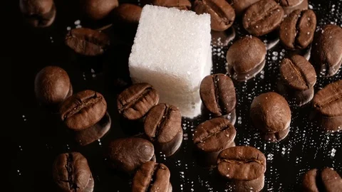 Coffee beans close-up rotate with a mirror image and a sugar cube Stock Footage 74775569