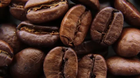 Coffee beans close-up rotates. Roasted arabica coffee beans. Coffee background. Video stock 242490529