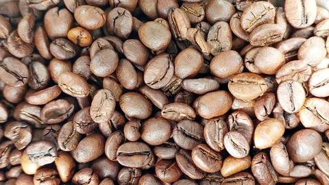 Coffee beans in a close view showcasing their rich texture and various shad.. Stock Photos