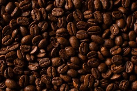 Coffee beans closeup pattern on black background Stock Photos