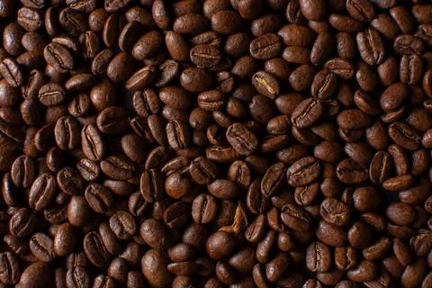 Coffee beans closeup pattern on black background Stock Photos