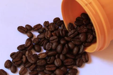 Coffee beans in coffee container isolated on white. Foto stock