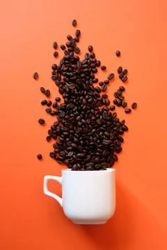 Coffee beans in coffee cup isolated on white Stock Photos