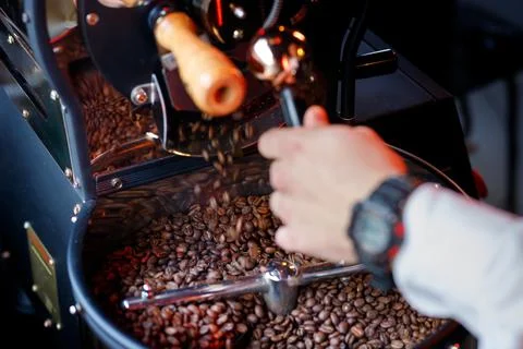 Coffee beans in a coffee machine, in dark colors. Stock Photos