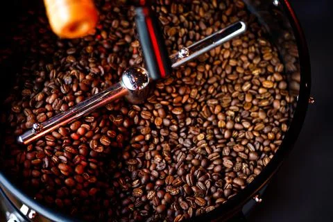 Coffee beans in a coffee machine, in dark colors. Stock Photos