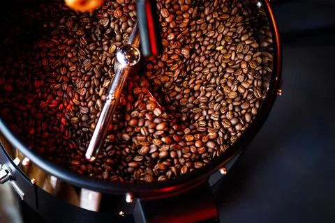 Coffee beans in a coffee machine, in dark colors. Stock Photos