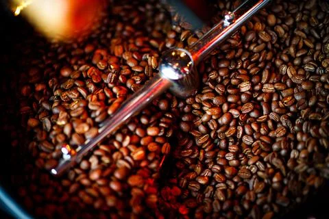 Coffee beans in a coffee machine, in dark colors. Stock Photos