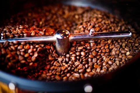 Coffee beans in a coffee machine, in dark colors. Stock Photos