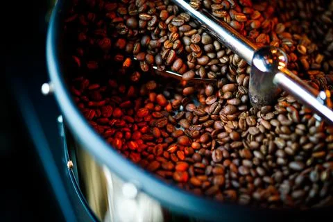 Coffee beans in a coffee machine, in dark colors. Stock Photos